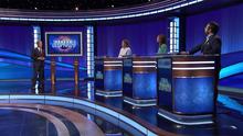 Ken Jennings and contestants on the Jeopardy! stage