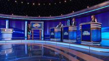Mayim Bialik and contestants Ryan Long, Eric Ahasic, and Stephanie Garrison on stage.